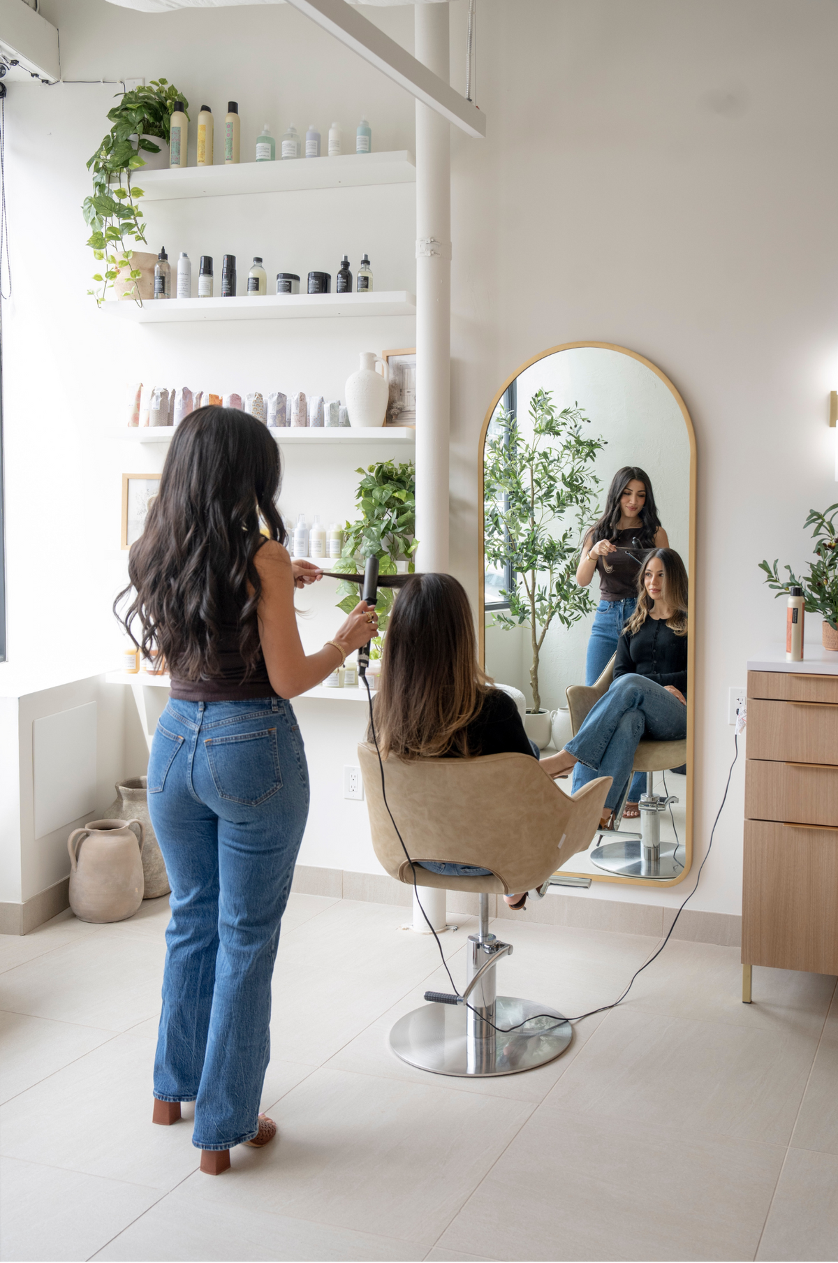 A stylist finishing a blowout at Maria Aiello Salon